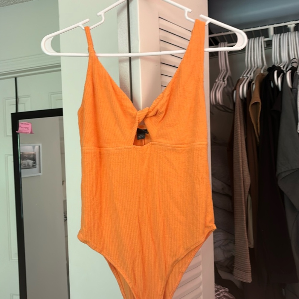 orange asymmetrical bodysuit